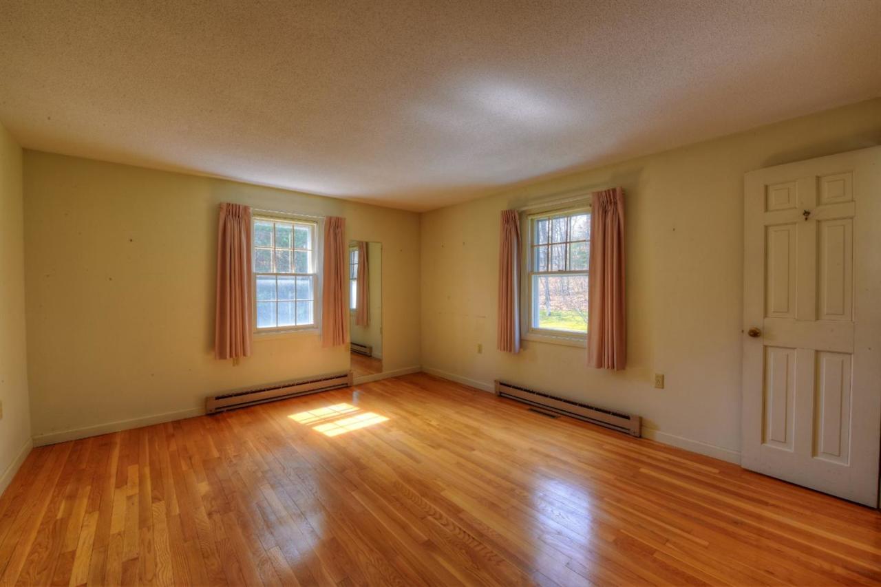 1394 Old Post Road Marstons Mills, MA 02648 - Photo 7 of 35 an empty room with wooden floor and windows