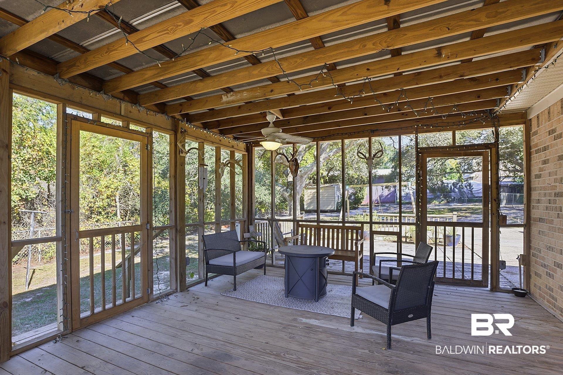 25793 Bonito Avenue Orange Beach, AL 36561 - Photo 25 of 27 Sunroom with a wooden deck and ceiling fan