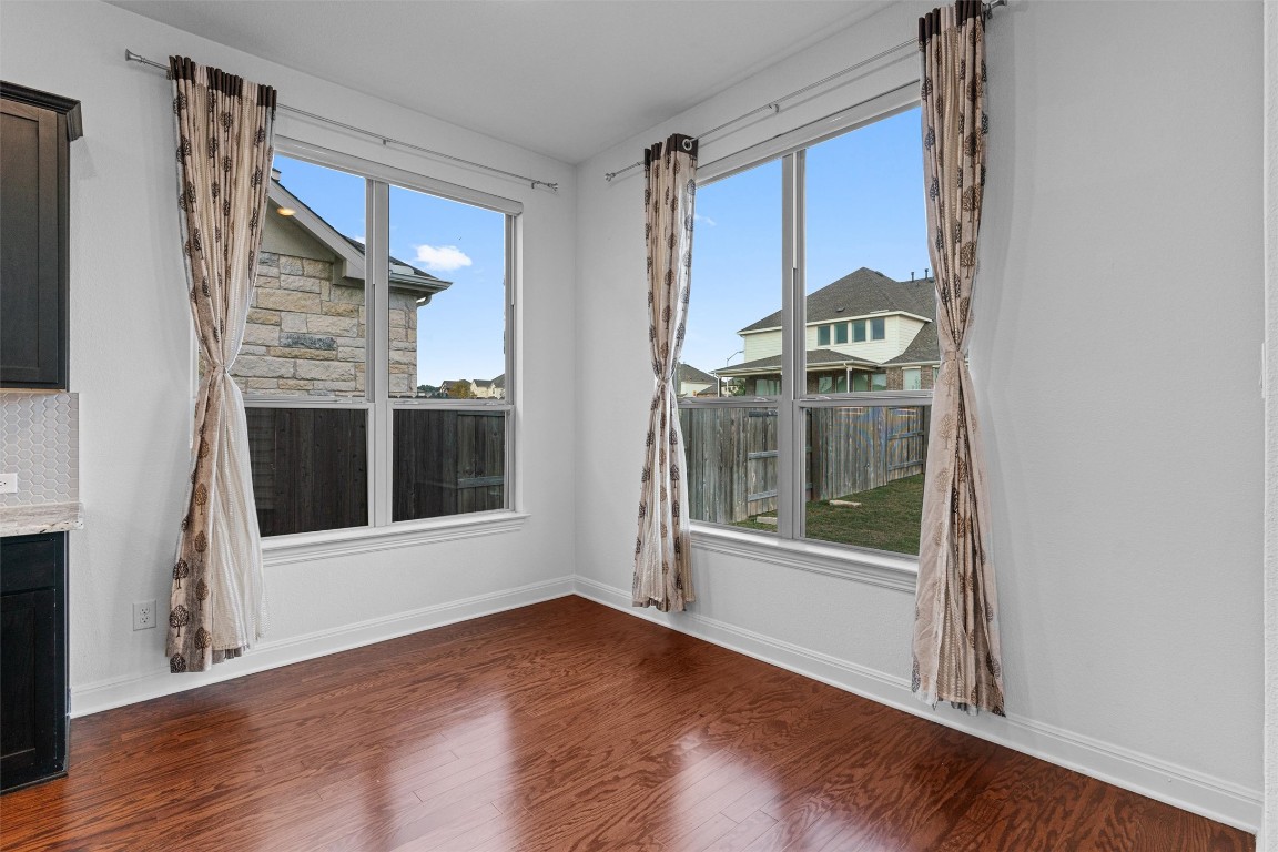 2328 Lucky Lane Leander, TX 78641 - Photo 12 of 40 an empty room with wooden floor and windows