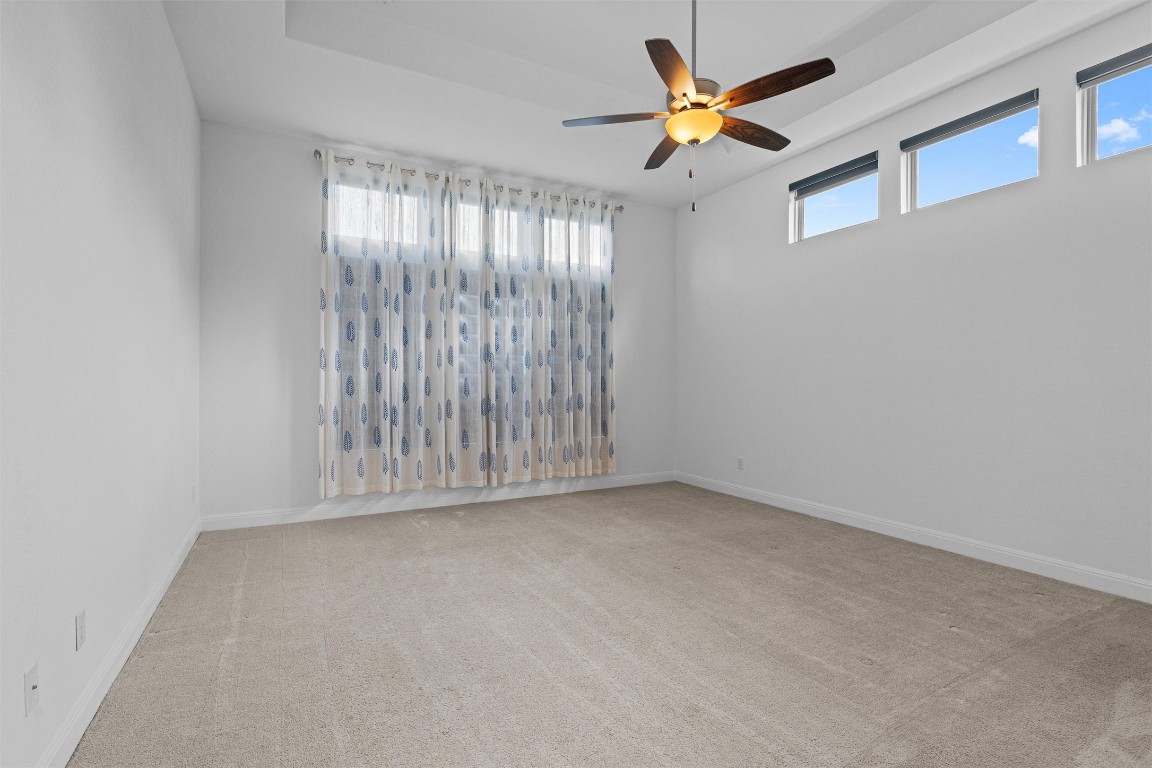 2328 Lucky Lane Leander, TX 78641 - Photo 13 of 40 an empty room with chandelier fan and window