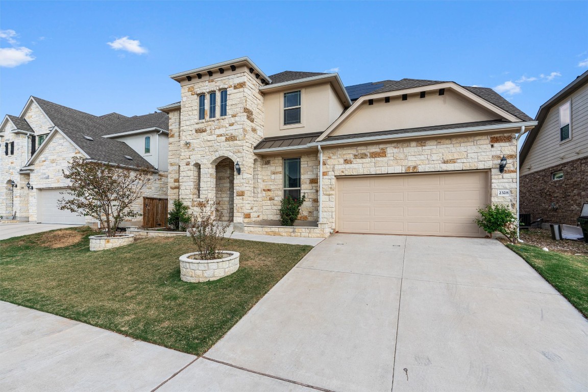 2328 Lucky Lane Leander, TX 78641 - Photo 2 of 40 a front view of a house with garden and parking
