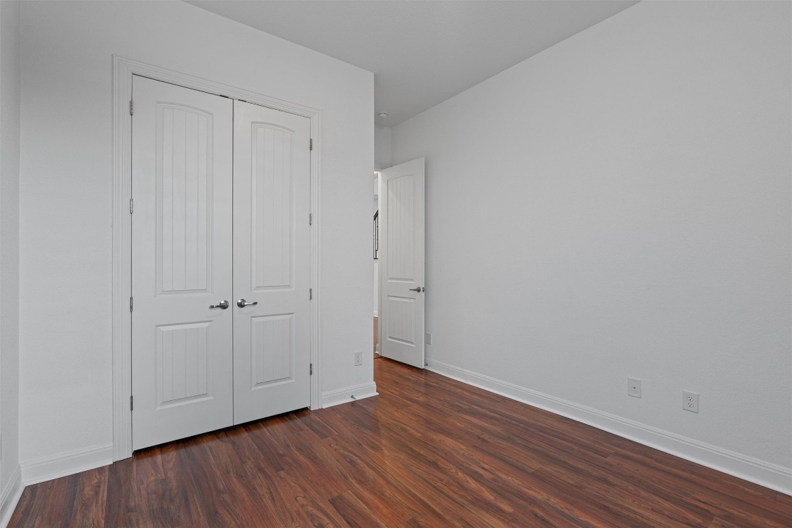 2328 Lucky Lane Leander, TX 78641 - Photo 21 of 40 a view of an empty room with closet and wooden floor