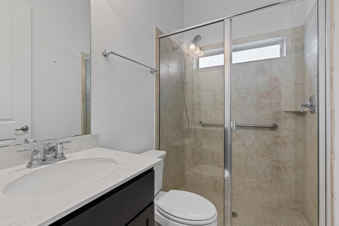 2328 Lucky Lane Leander, TX 78641 - Photo 22 of 40 a bathroom with a sink a toilet and shower