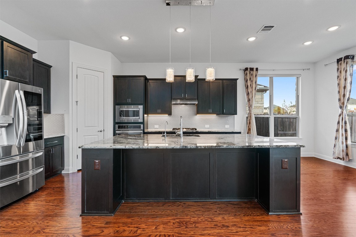 2328 Lucky Lane Leander, TX 78641 - Photo 9 of 40 a kitchen with stainless steel appliances granite countertop a refrigerator and a sink