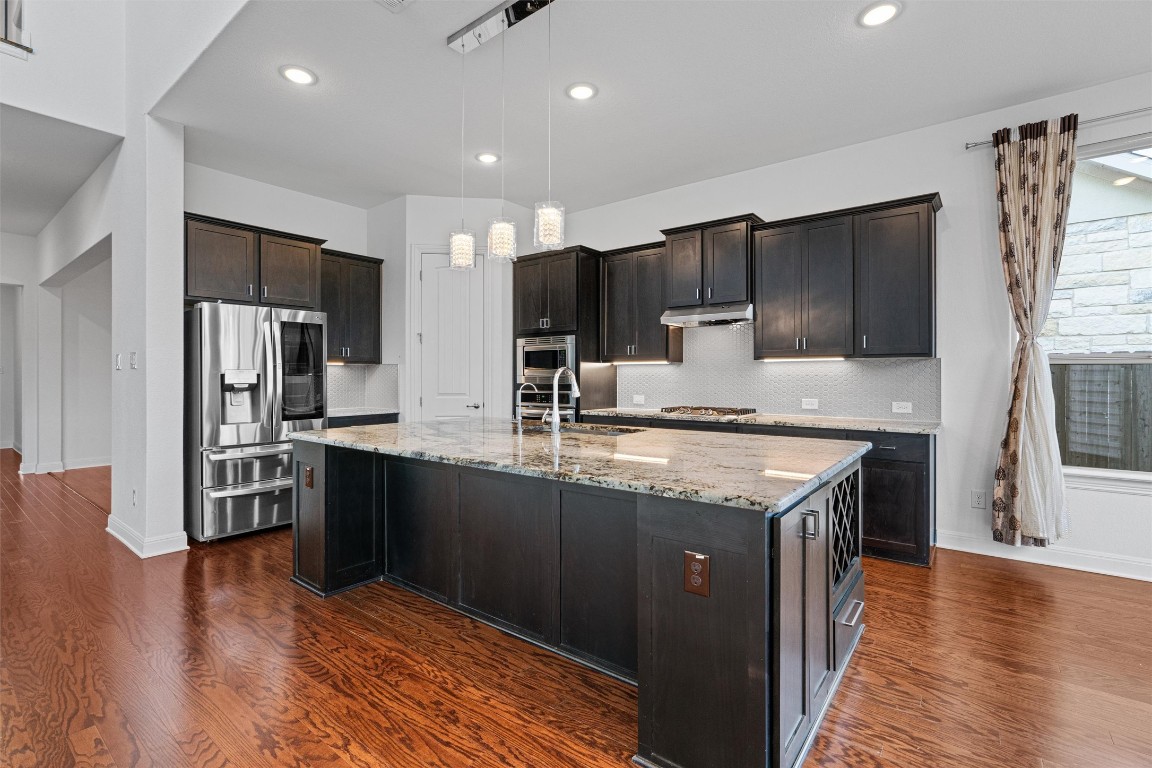 2328 Lucky Lane Leander, TX 78641 - Photo 10 of 40 a kitchen with stainless steel appliances granite countertop a sink stove and refrigerator