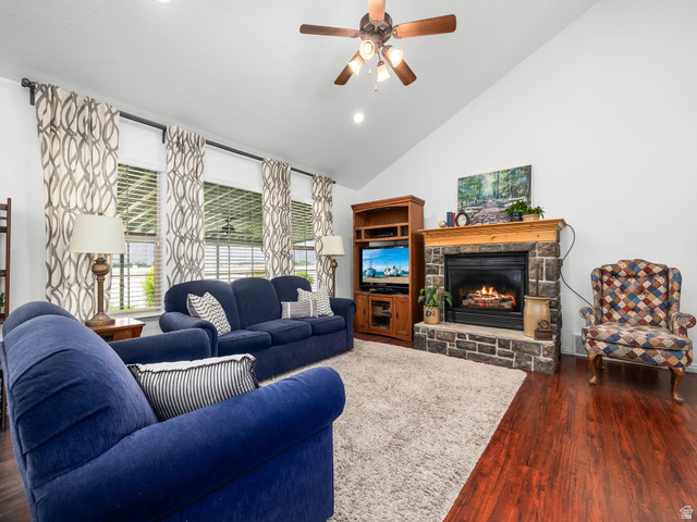 1602 Renaissance Way Springville, UT 84663 - Photo 6 of 42 Living area featuring a stone fireplace with a wood mantel, vaulted ceilings, and rich wood-finish flooring