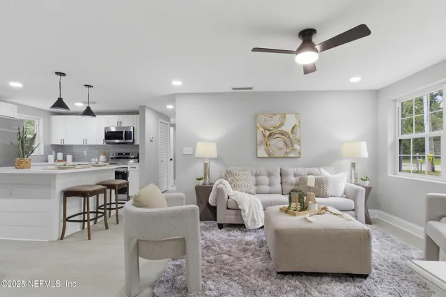 a living room with furniture and a large window