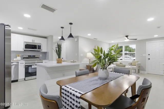 a kitchen with a table chairs stove and microwave