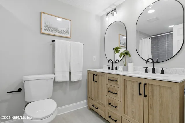a bathroom with a toilet sink and mirror