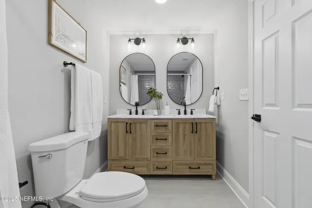 a bathroom with a toilet a sink and a mirror