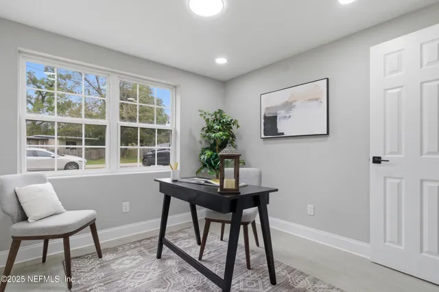 a workspace with furniture and a potted plant