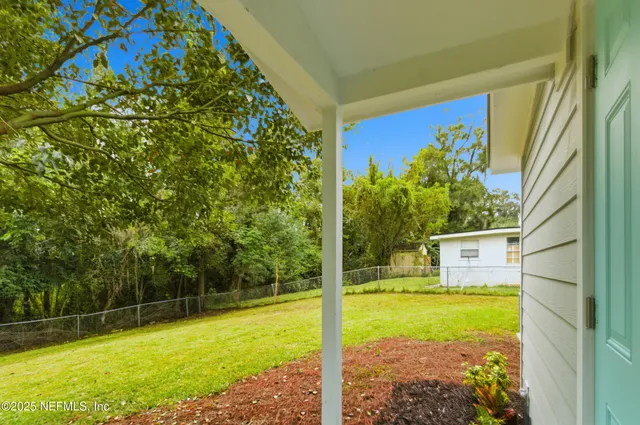 a view of a back yard from a balcony
