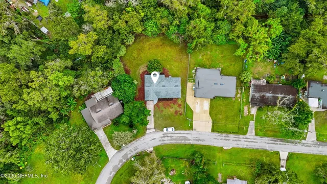 an aerial view of a house with garden space and street view