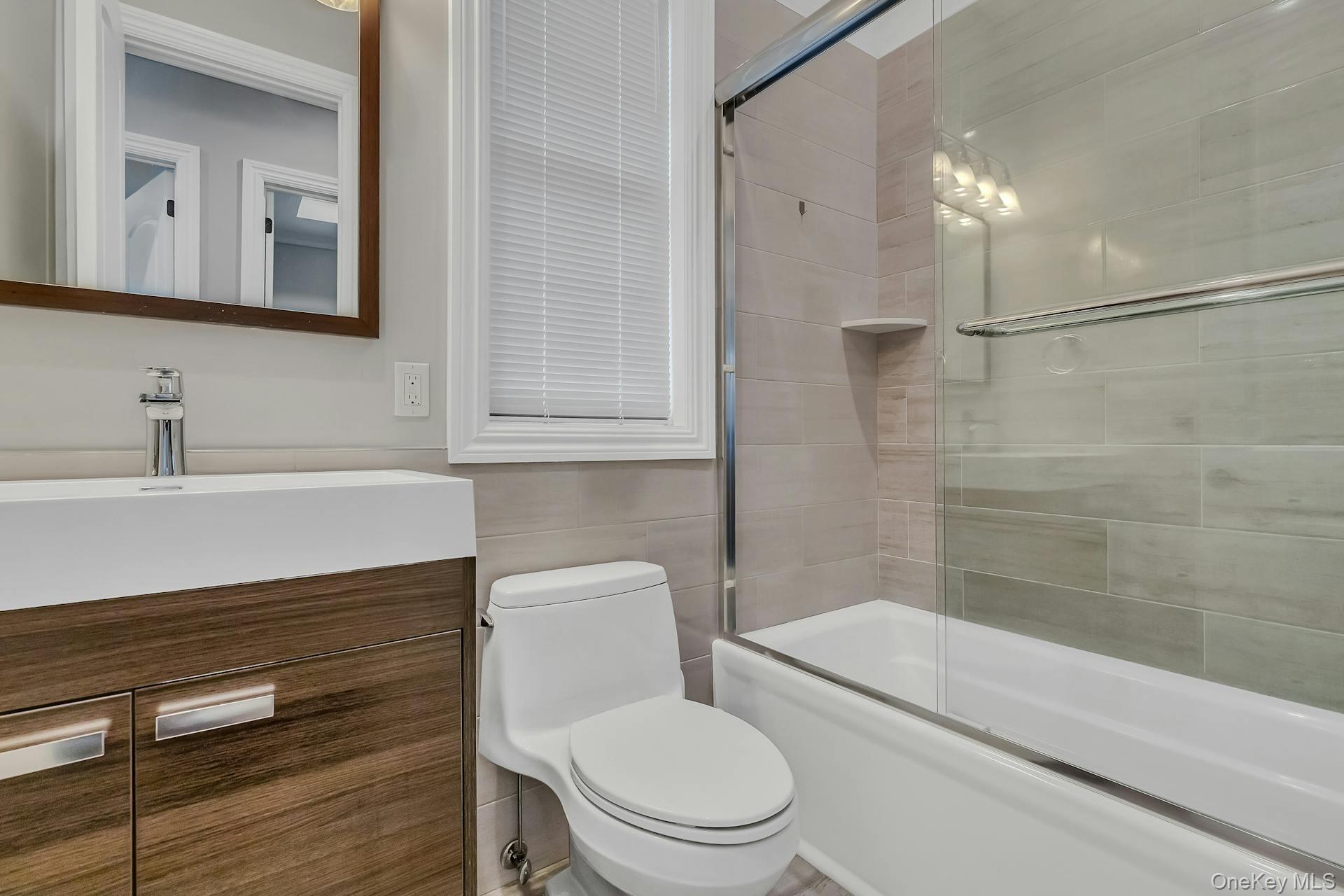 2 Seaman Road Glen Cove, NY 11542 - Photo 9 of 17 Second floor bathroom tub and shower, vanity mirror.