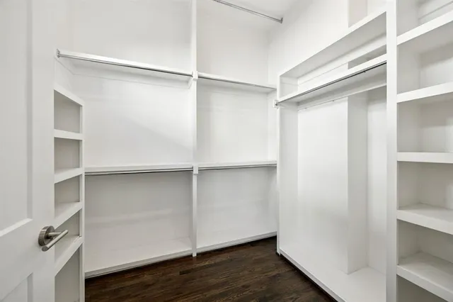a view of walk in closet with empty racks
