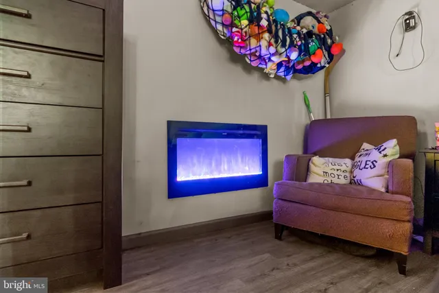 a living room with furniture a flowers and a wooden floor