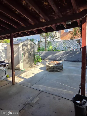 a view of a porch with furniture and a yard