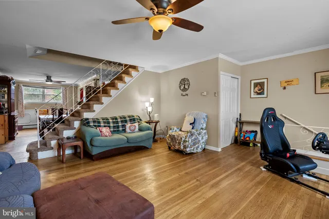 a living room with furniture a air conditioner vent and a window
