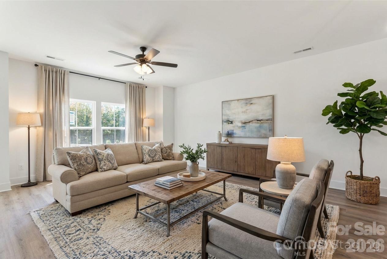 a living room with furniture and a large window