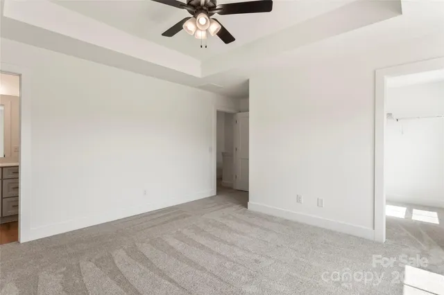 a bathroom with a sink a toilet and a large mirror