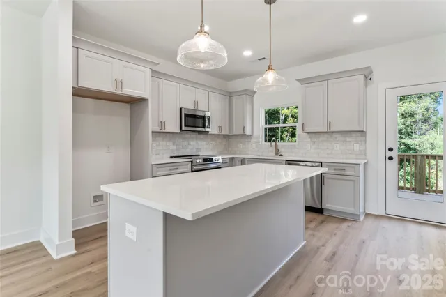 a kitchen with kitchen island white cabinets and white appliances