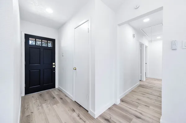 a view of hallway with wooden floor