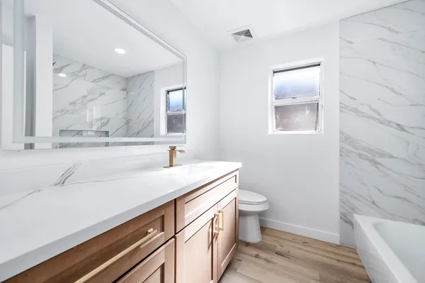 a bathroom with a sink a toilet and a bathtub