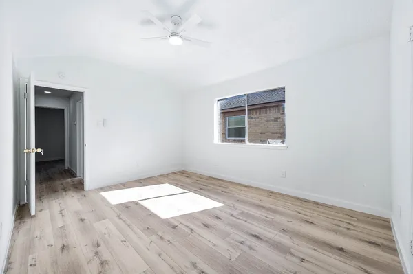 wooden floor in an empty room with a window