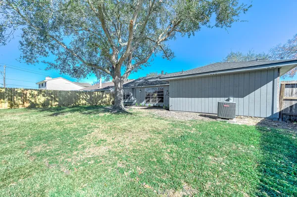 a backyard of a house with table and chairs