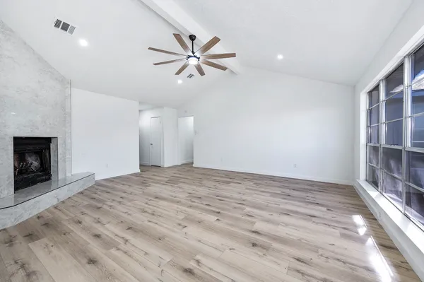 wooden floor in an empty room with a window