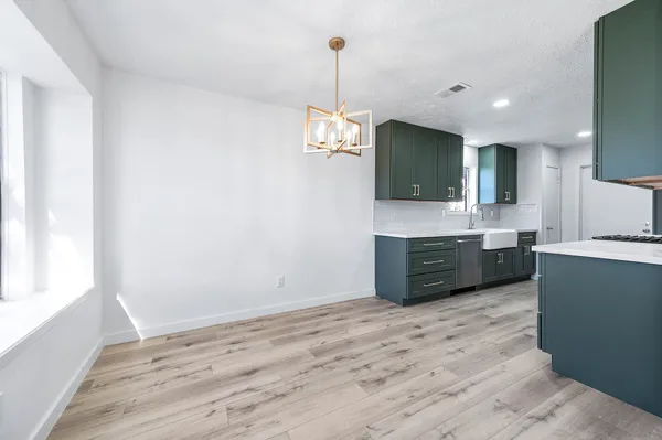 a kitchen with kitchen island a sink stainless steel appliances and cabinets