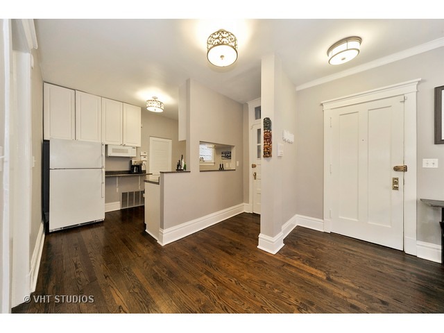 725 West Buckingham Place, Unit 1 Chicago, IL 60657 - Photo 2 of 12 a kitchen with stainless steel appliances granite countertop a refrigerator sink and white cabinets