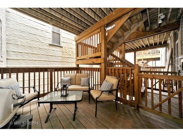 725 West Buckingham Place, Unit 1 Chicago, IL 60657 - Photo 11 of 12 a balcony view with chairs and wooden floor