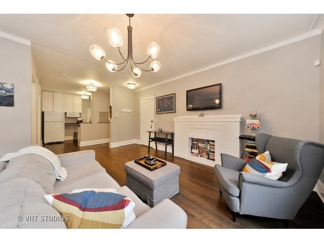725 West Buckingham Place, Unit 1 Chicago, IL 60657 - Photo 4 of 12 a living room with furniture a fireplace and a flat screen tv