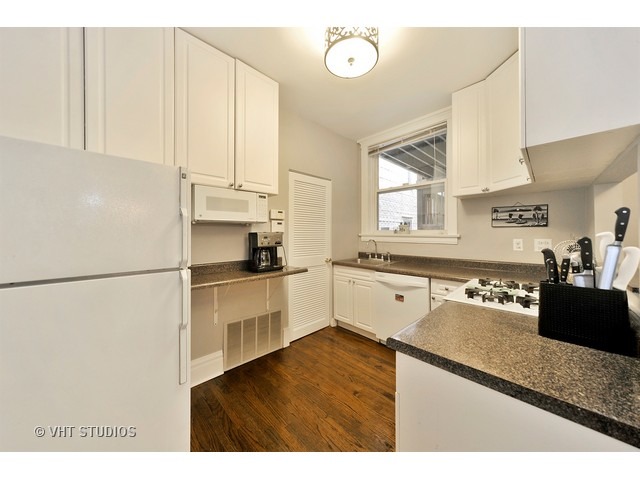 725 West Buckingham Place, Unit 1 Chicago, IL 60657 - Photo 6 of 12 a kitchen with a refrigerator and a sink