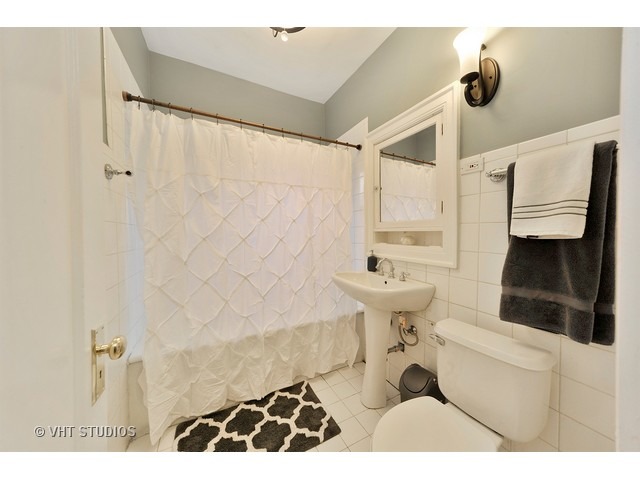725 West Buckingham Place, Unit 1 Chicago, IL 60657 - Photo 8 of 12 a bathroom with a sink toilet and shower