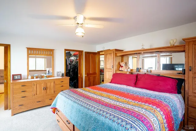 a bedroom with a large bed and a window