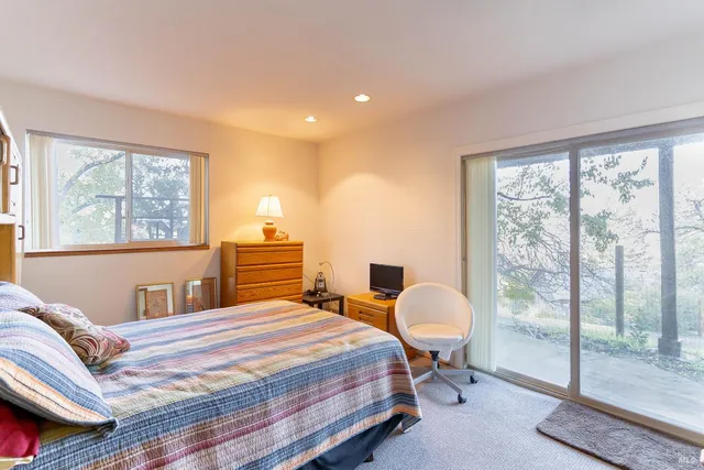 a bedroom with double bed and a window