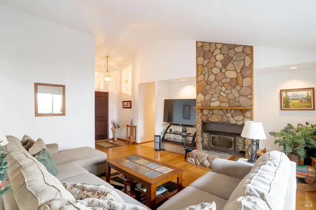 a living room with furniture and a fireplace