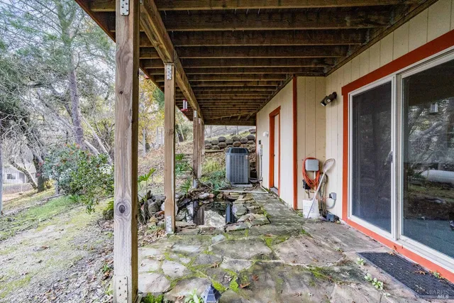 a view of a porch with furniture and floor to ceiling window