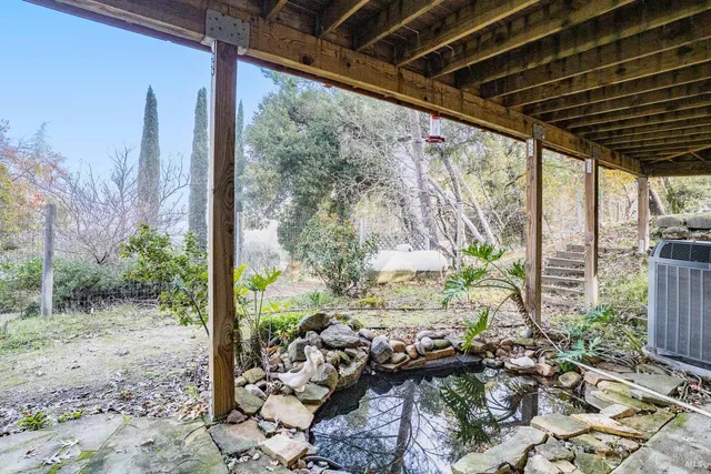 a view of a porch with furniture and yard
