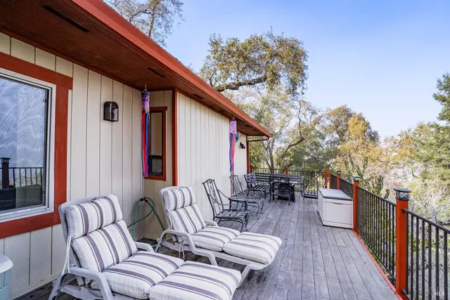 a balcony with furniture and wooden floor