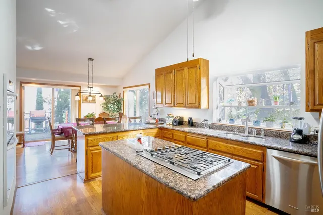 a kitchen that has a sink and a stove in it