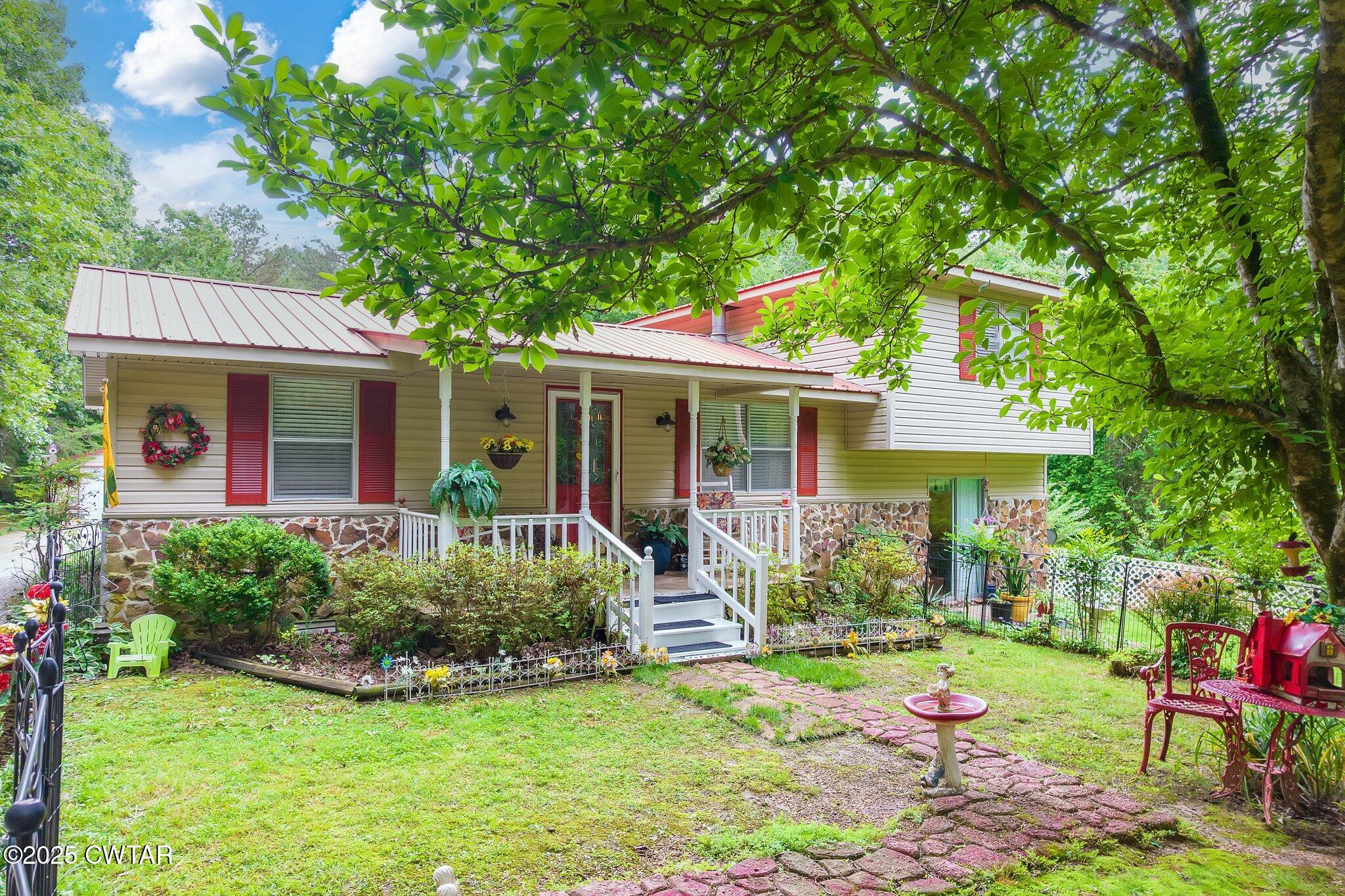 3600 Pine Top Road Toone, TN 38381 - Photo 1 of 39 a front view of a house with a yard table and chairs