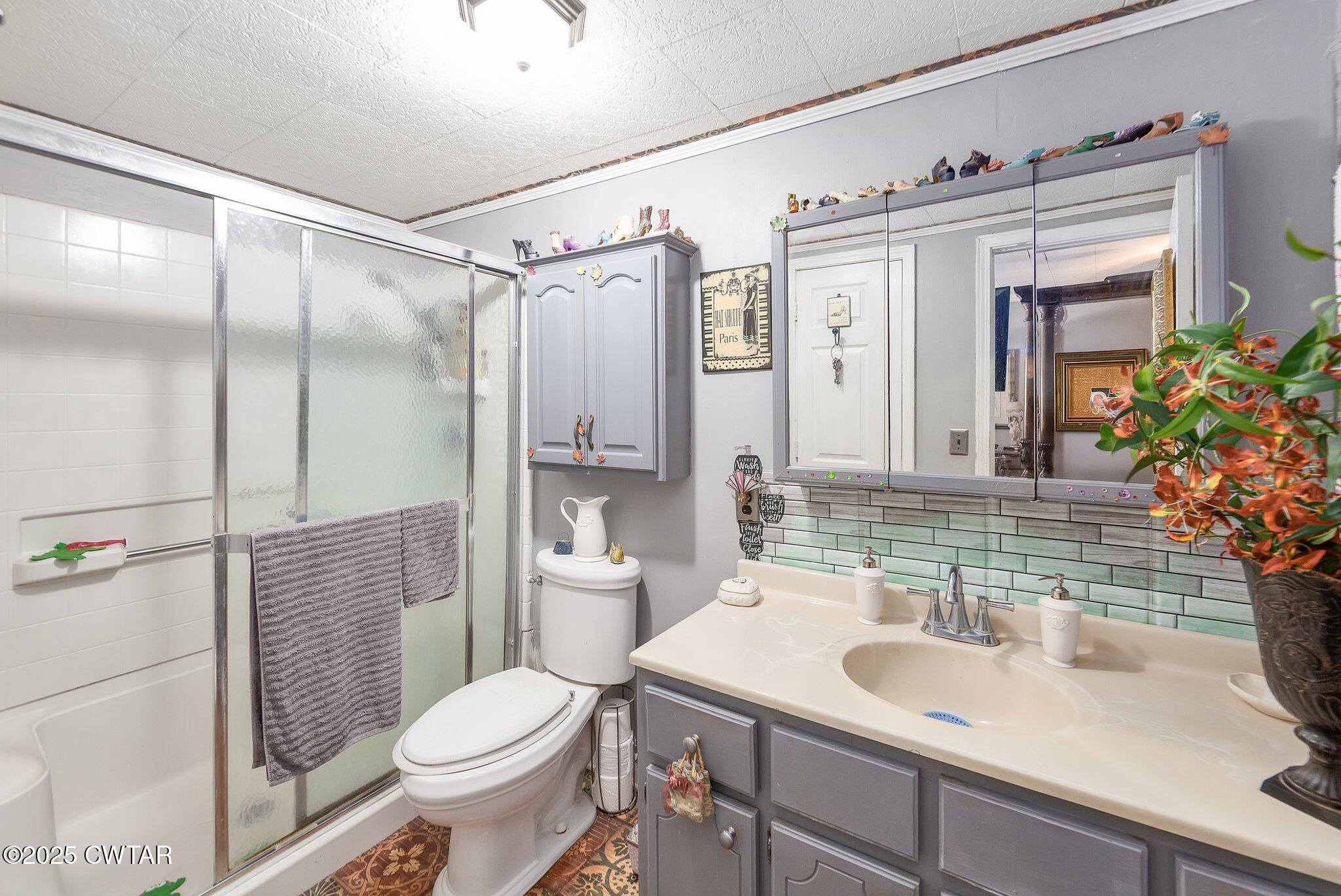 3600 Pine Top Road Toone, TN 38381 - Photo 20 of 39 a bathroom with a sink toilet and shower