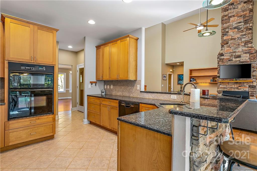 5628 Plantation Ridge Road Charlotte, NC 28214 - Photo 11 of 43 a kitchen with stainless steel appliances granite countertop a stove a sink and a microwave