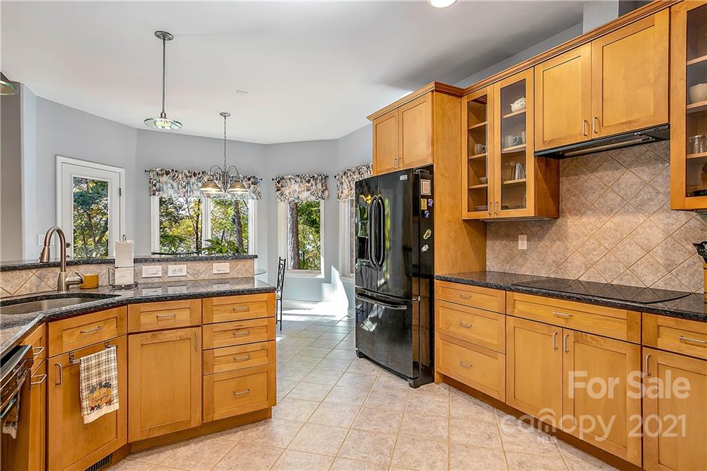 5628 Plantation Ridge Road Charlotte, NC 28214 - Photo 12 of 43 a kitchen with stainless steel appliances granite countertop a refrigerator a oven and white cabinets with wooden floors