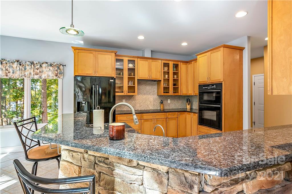 5628 Plantation Ridge Road Charlotte, NC 28214 - Photo 13 of 43 a kitchen with stainless steel appliances granite countertop a sink refrigerator and cabinets