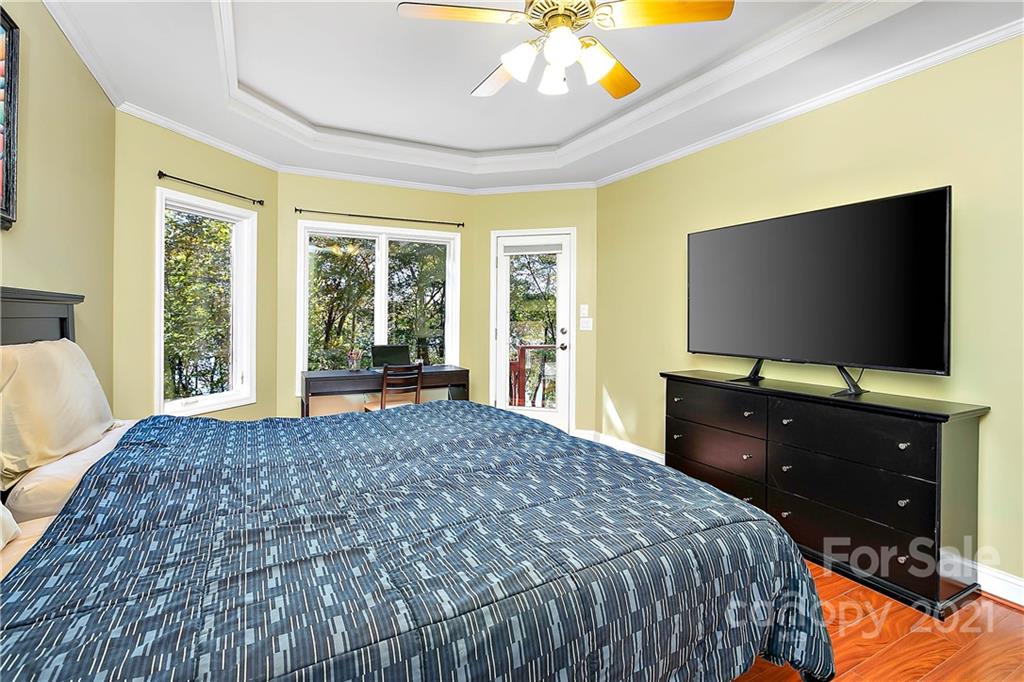 5628 Plantation Ridge Road Charlotte, NC 28214 - Photo 16 of 43 a bedroom with a bed and a flat screen tv