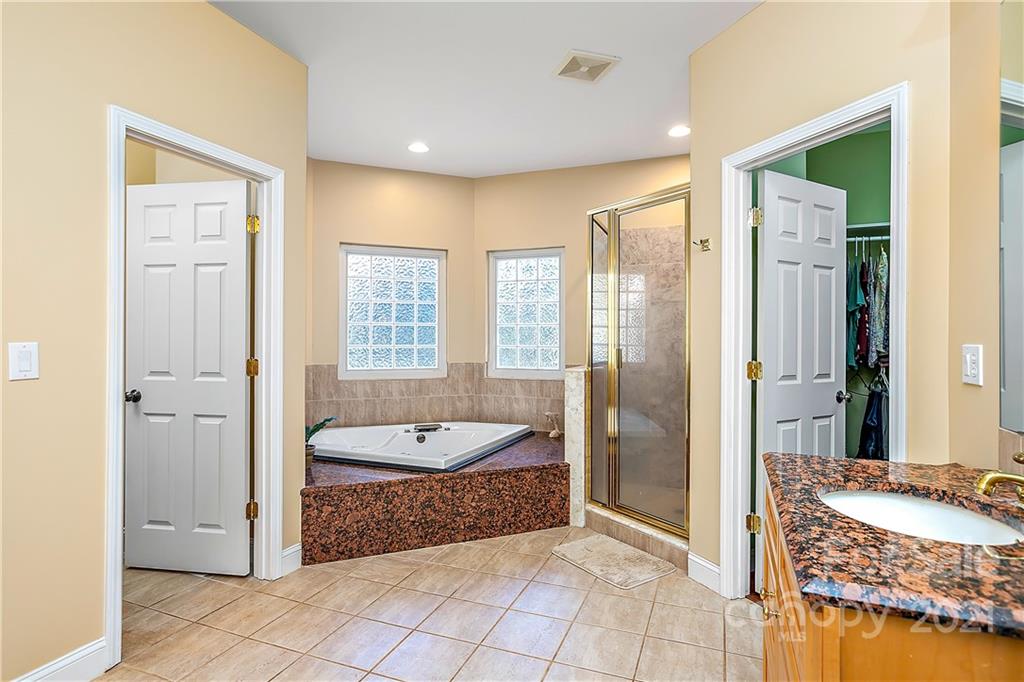 5628 Plantation Ridge Road Charlotte, NC 28214 - Photo 18 of 43 a spacious bathroom with a granite countertop tub shower and sink